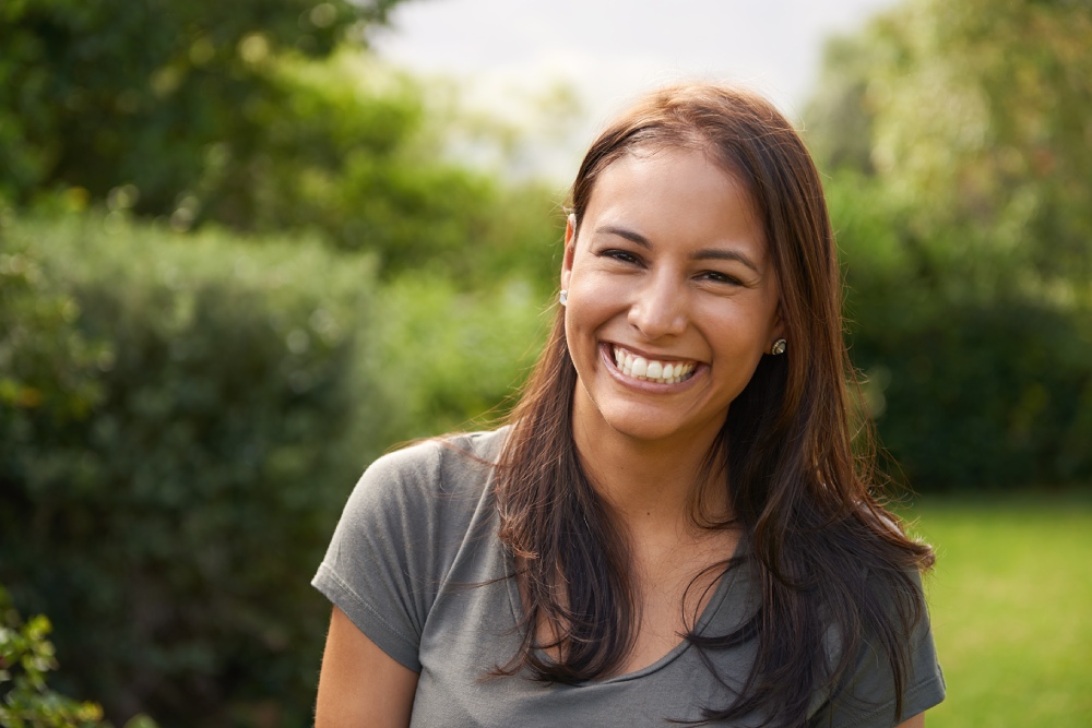 close-up of a woman smiling outdoors