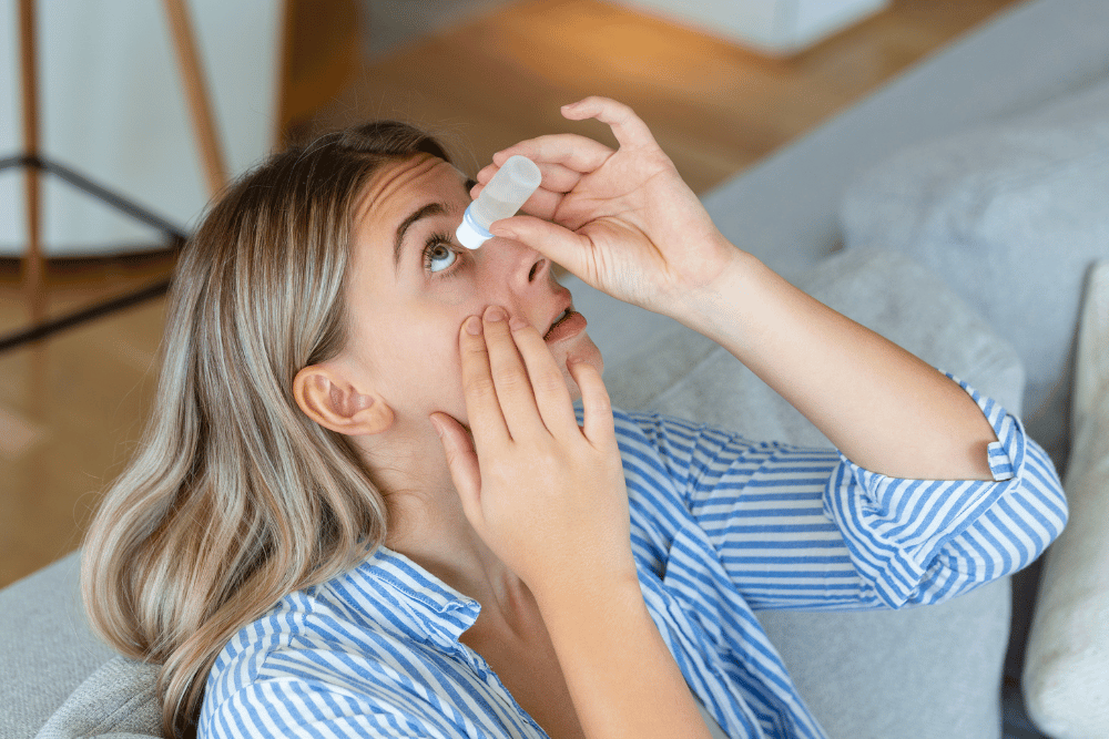 a woman putting in eye drops for dry eyes