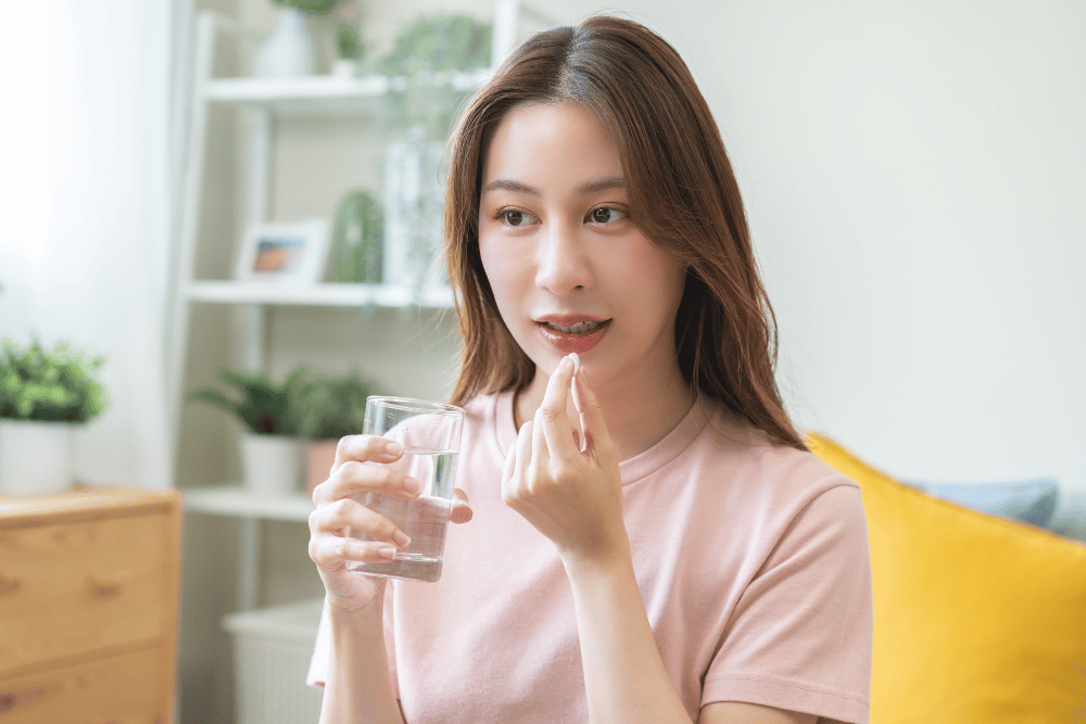 a woman taking a medication